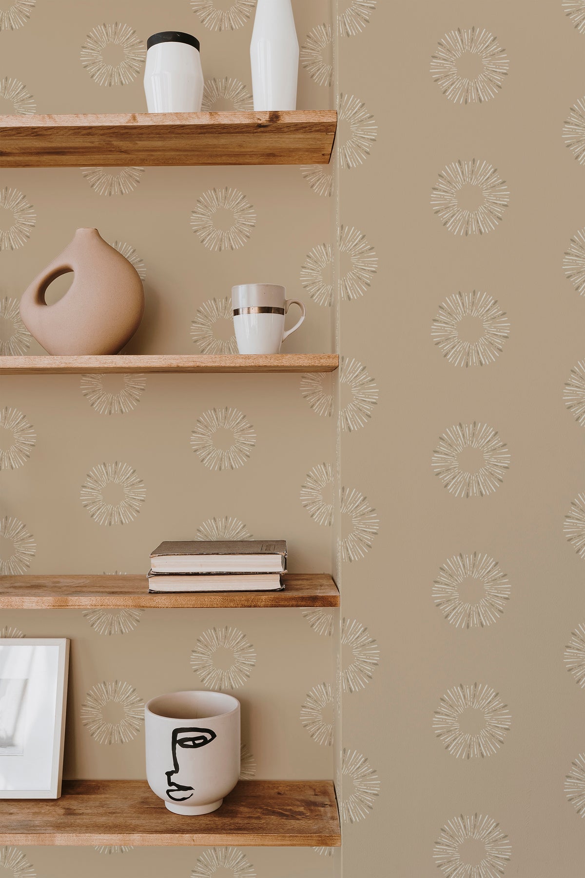 Sunburst Dots peel and stick wallpaper on an interior wall, white sunburst motifs on tan with an open repeat.