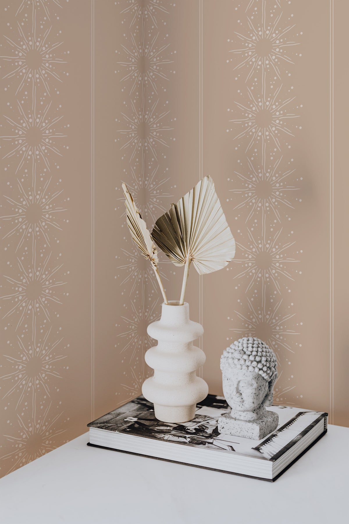 Dotted Starbursts peel and stick wallpaper on an interior wall with white dotted starburst motifs on tan.