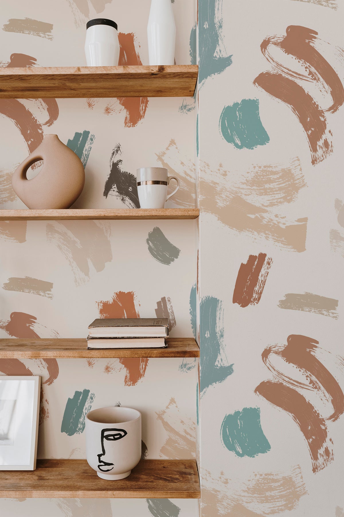 Playful Brush Stroke grasscloth wallpaper on an interior accent wall, with scattered teal and tan brush marks.