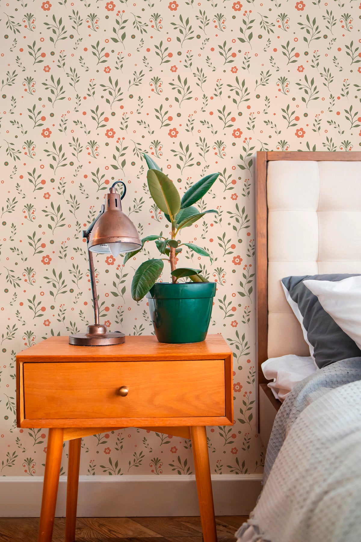Playful Floral Sprigs peel and stick wallpaper in a bedroom, green sprigs and orange flowers on a blush ground.