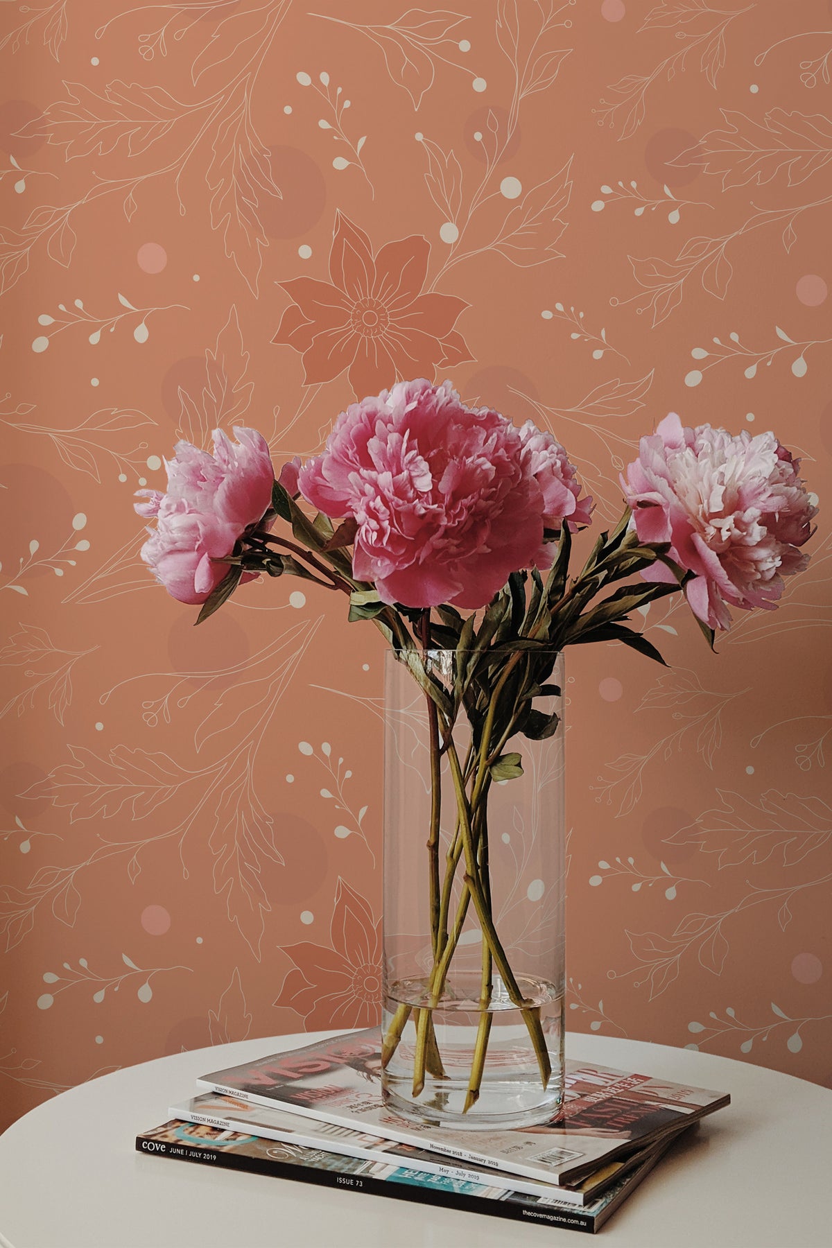 Delicate Floral Sprigs peel and stick wallpaper on an interior wall with fine white floral outlines on terracotta.
