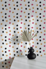 Self-adhesive wallpaper with a colorful dots pattern in black, yellow, and pink on a white background, adding a playful and vibrant touch to the room.