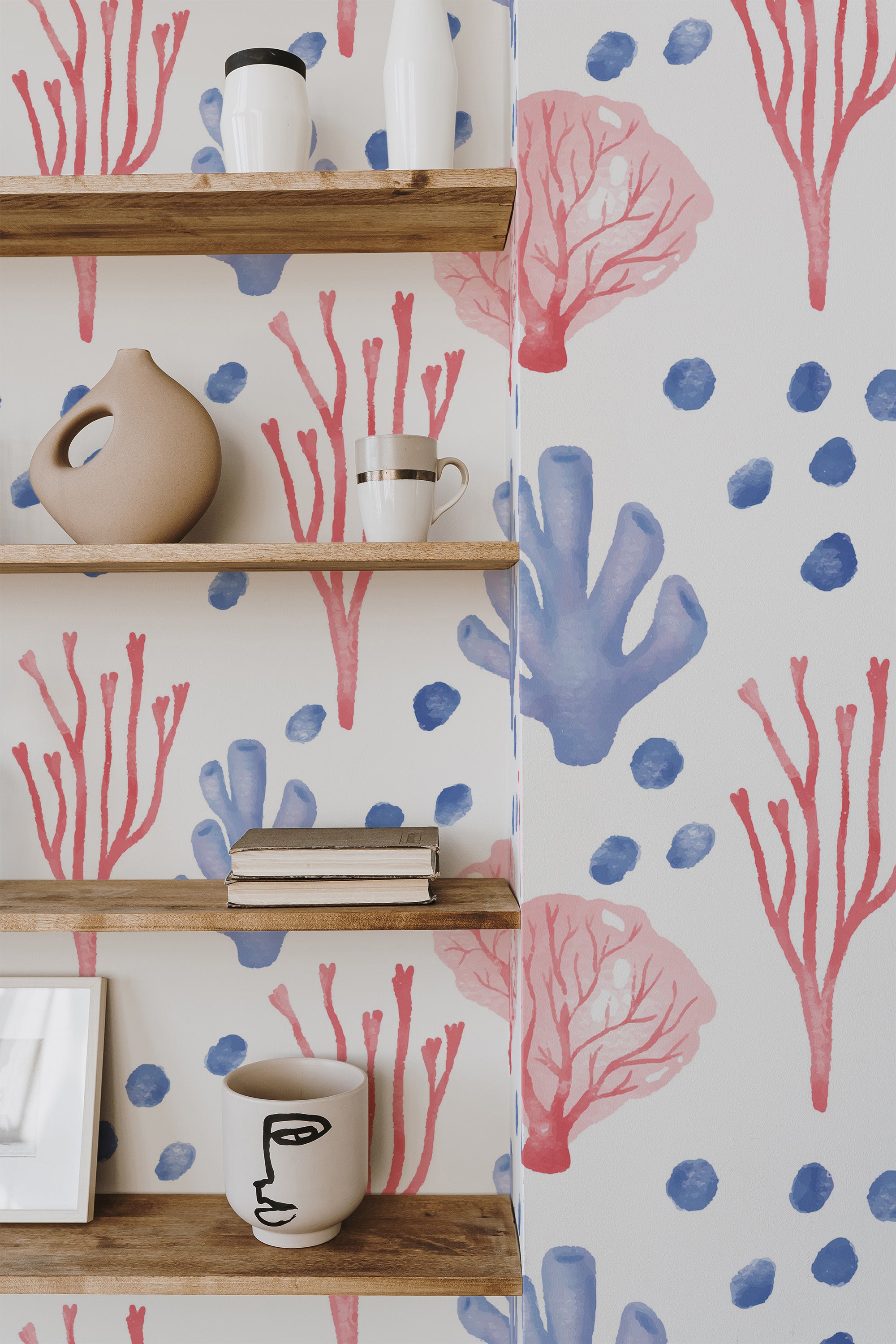 Self-adhesive wallpaper with a watercolor coral design of red and blue corals paired with soft blue dots, creating a fresh and serene ocean-inspired look.