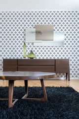 Wall adorned with wallpaper featuring a geometric pattern of evenly spaced squares in a lattice-like design, enhancing the room with a modern yet traditional wallpaper.