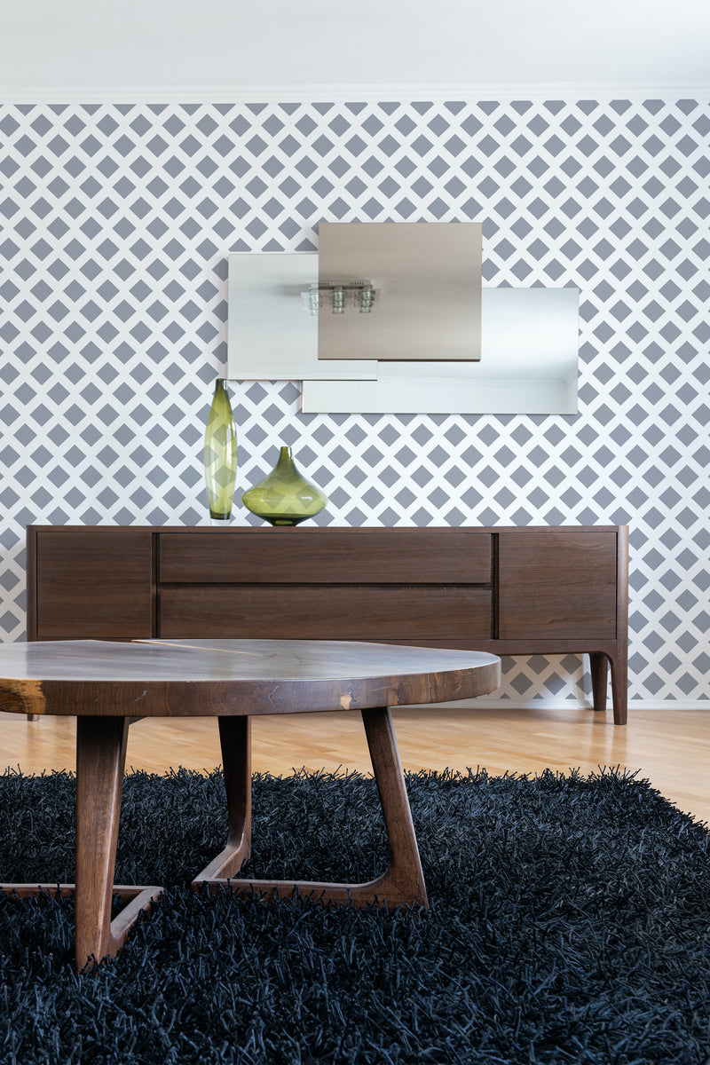 Wall adorned with wallpaper featuring a geometric pattern of evenly spaced squares in a lattice-like design, enhancing the room with a modern yet traditional wallpaper.