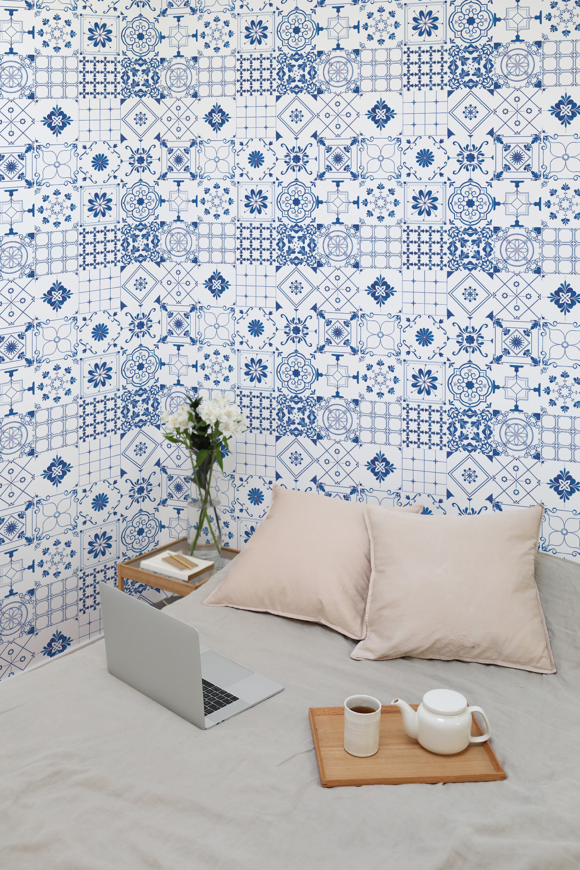 Self-adhesive Blue Tile Collection wallpaper with intricate geometric patterns and floral motifs in shades of blue and white, creating a vintage and artistic appeal in the room.