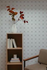 Self-adhesive wallpaper with a geometric floral pattern, featuring small, evenly spaced flower shapes in a grid layout. The backdrop is off-white with delicate, simple outlines of flowers, creating a subtle and modern look in the room.