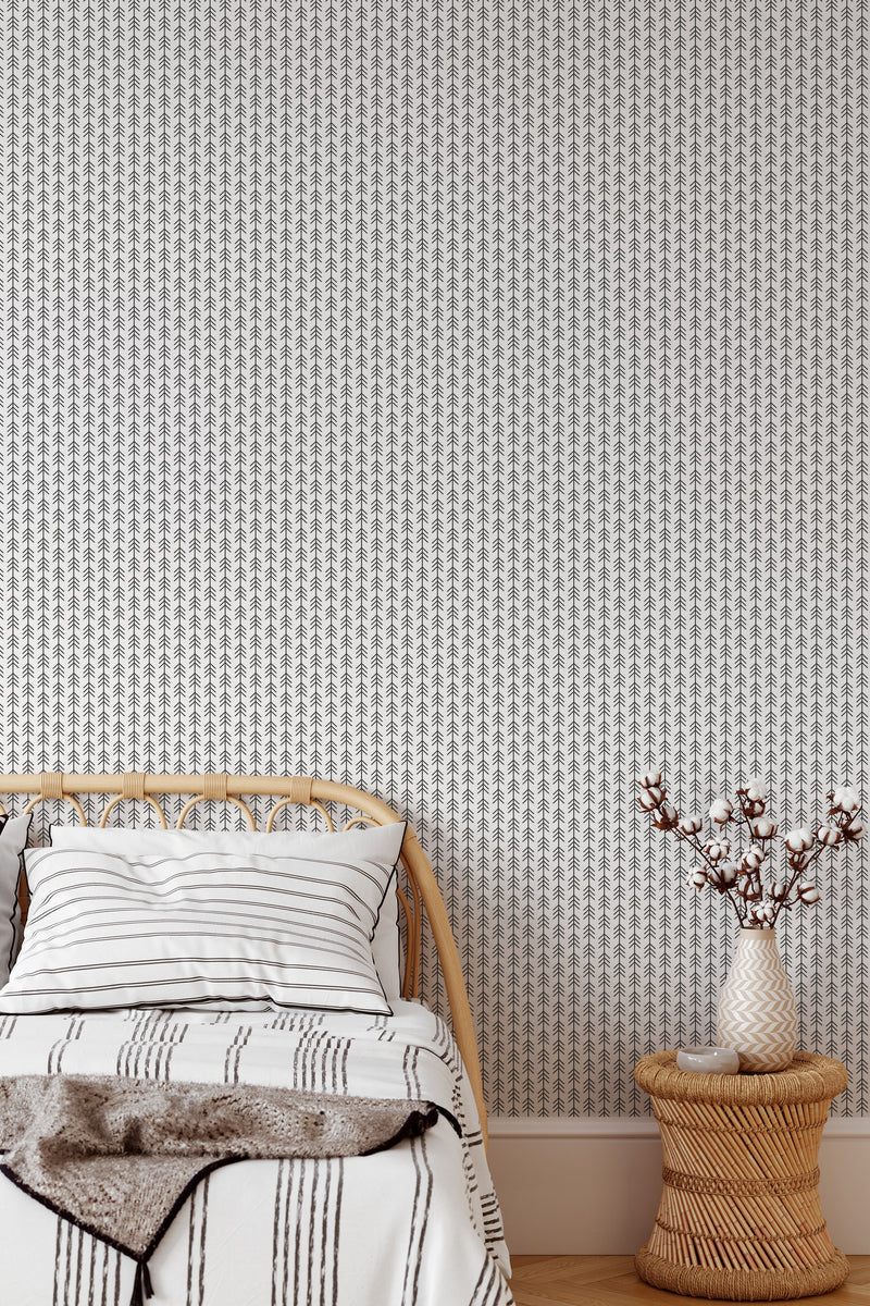 Self-adhesive wallpaper with a sleek arrow lines pattern in a monochromatic color scheme, creating a modern and subtle geometric design on the wall behind a bed with a rattan headboard.