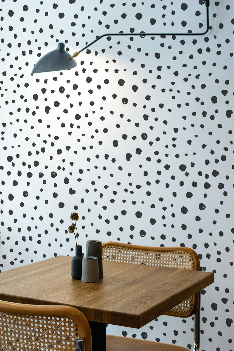 Self-adhesive wallpaper with a seamless dot design of irregular black dots scattered across a white background, creating a modern, playful vibe.