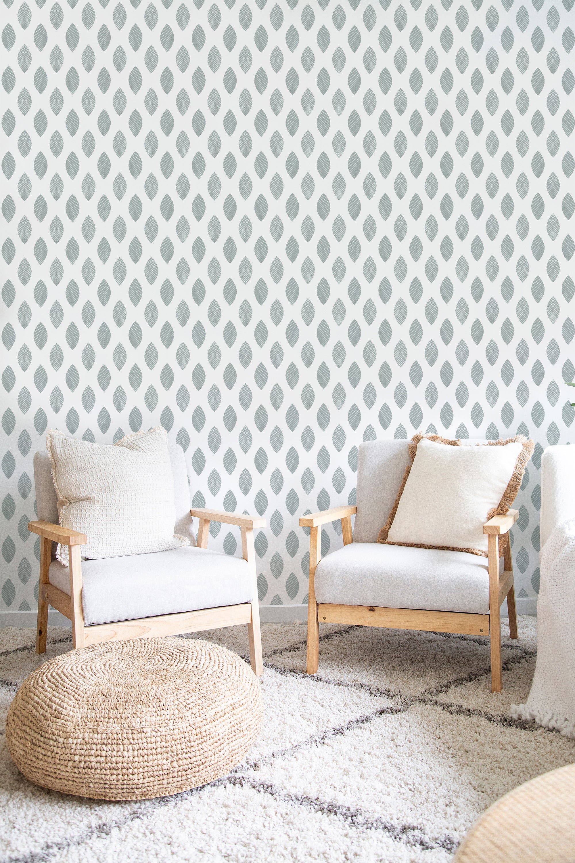 Wallpaper with a repeating pattern of soft, muted leaf-shaped motifs arranged in vertical columns on a neutral background, traditional wallpaper.