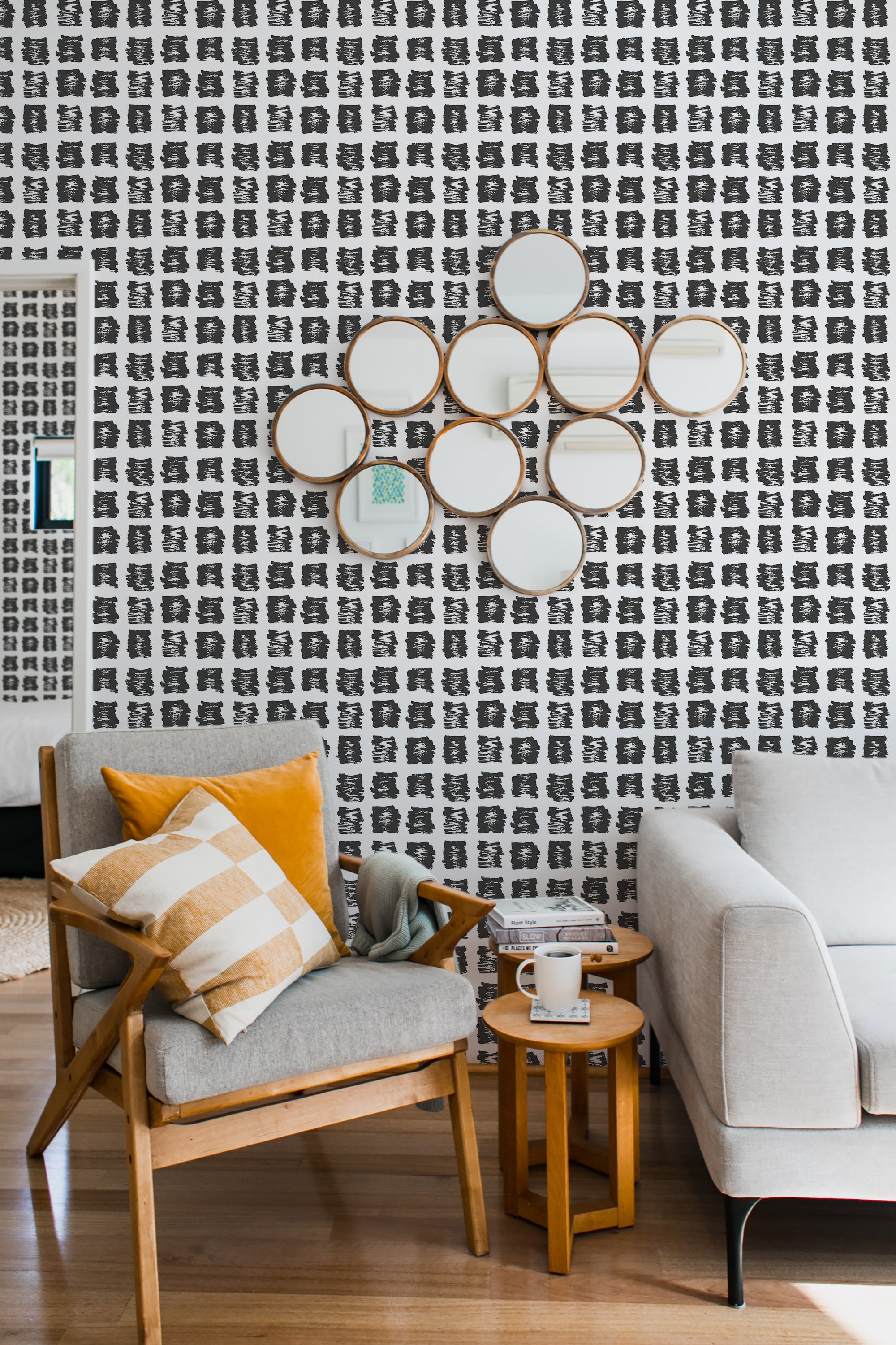 Wallpaper with a repeating pattern of small, black paint splatter spots on a white background, covering the entire wall. Traditional wallpaper.