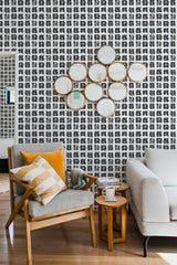 living room cozy sofa armchair pillows decor paint spots peel stick wallpaper