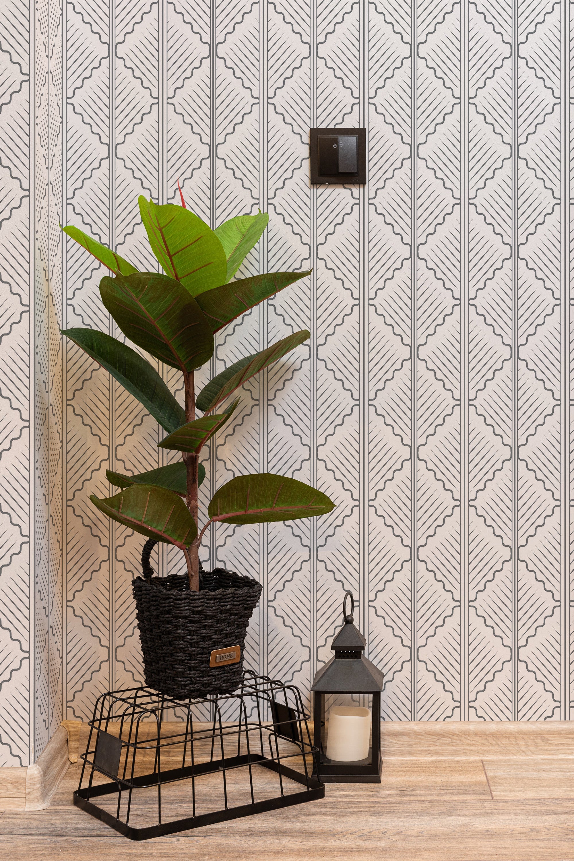 Self-adhesive Quatrefoil wallpaper with an intricate geometric pattern of interlocking shapes in black and white, adding a modern, stylish touch to the room.