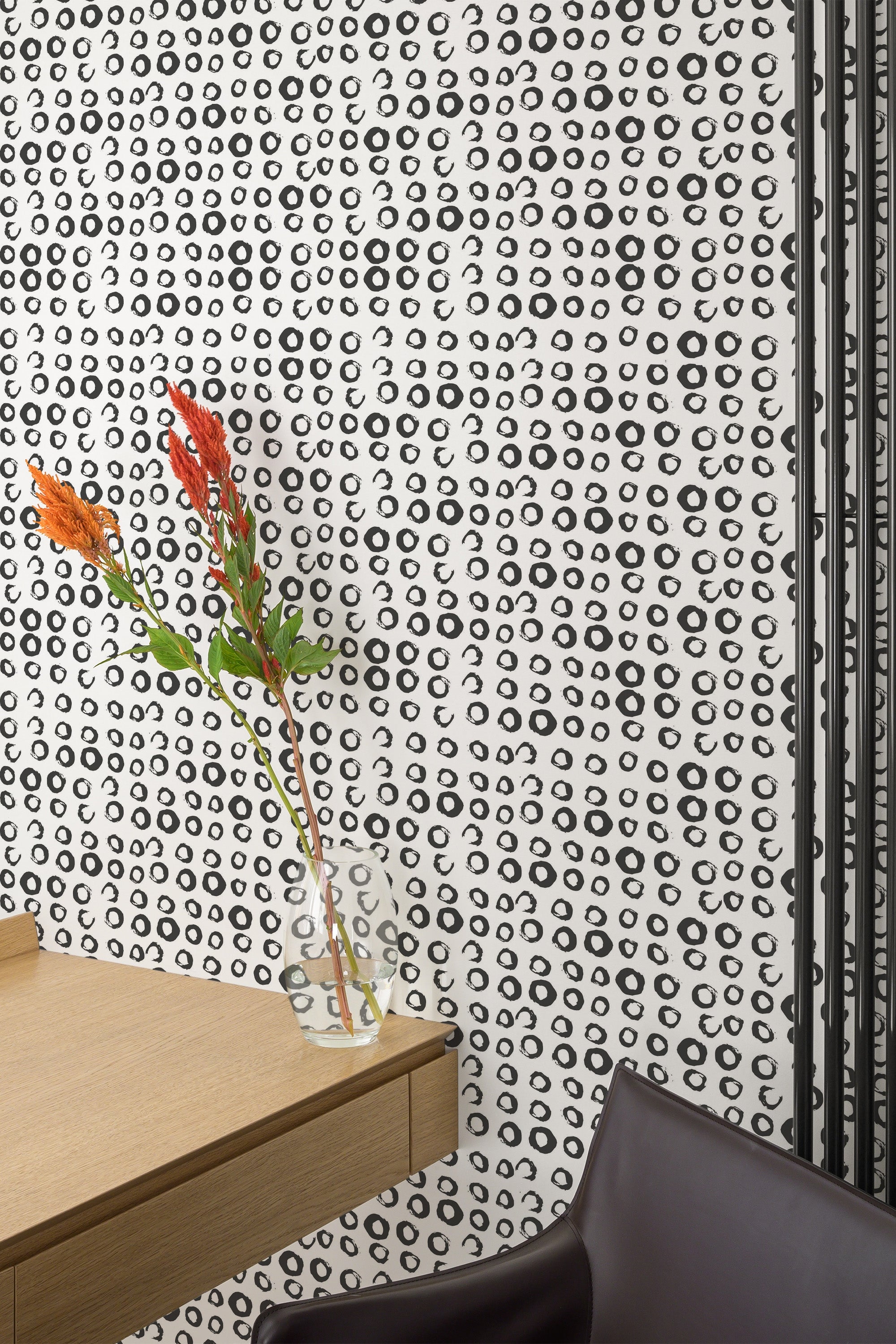Self-adhesive wallpaper with a small circles pattern in black scattered across a white background, creating a modern, minimalist look.