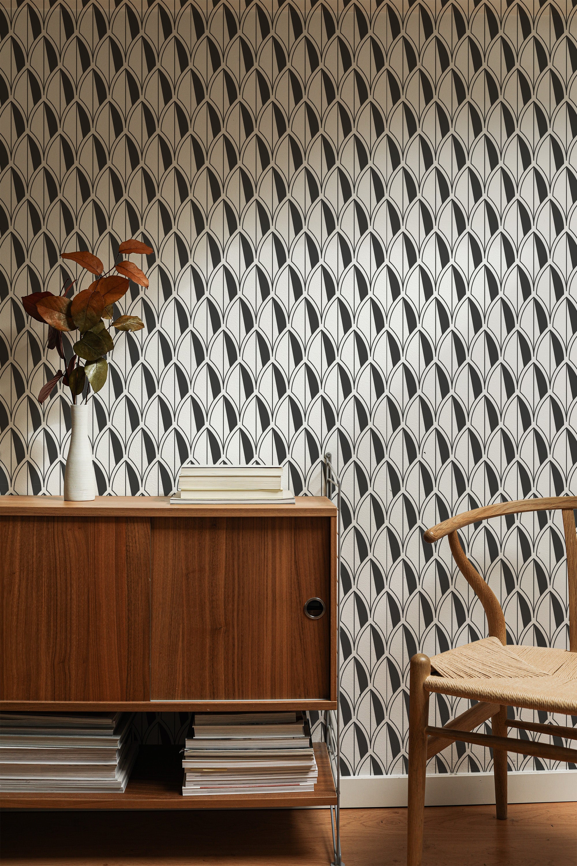 Self-adhesive wallpaper with an Art Deco leaves design in a black and white palette, creating a pattern of repeating symmetrical arches against a light background.