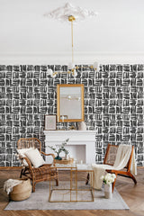 Black brushstroke pattern on a white background creates a modern and artistic feel in the room, while maintaining a timeless elegance with traditional wallpaper.