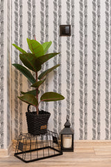 Self-adhesive wallpaper with a brush stroke herringbone pattern in black on a white background.