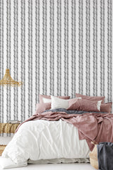 Wallpaper with a herringbone pattern created by brush strokes in varying shades of gray, arranged vertically. Traditional wallpaper.