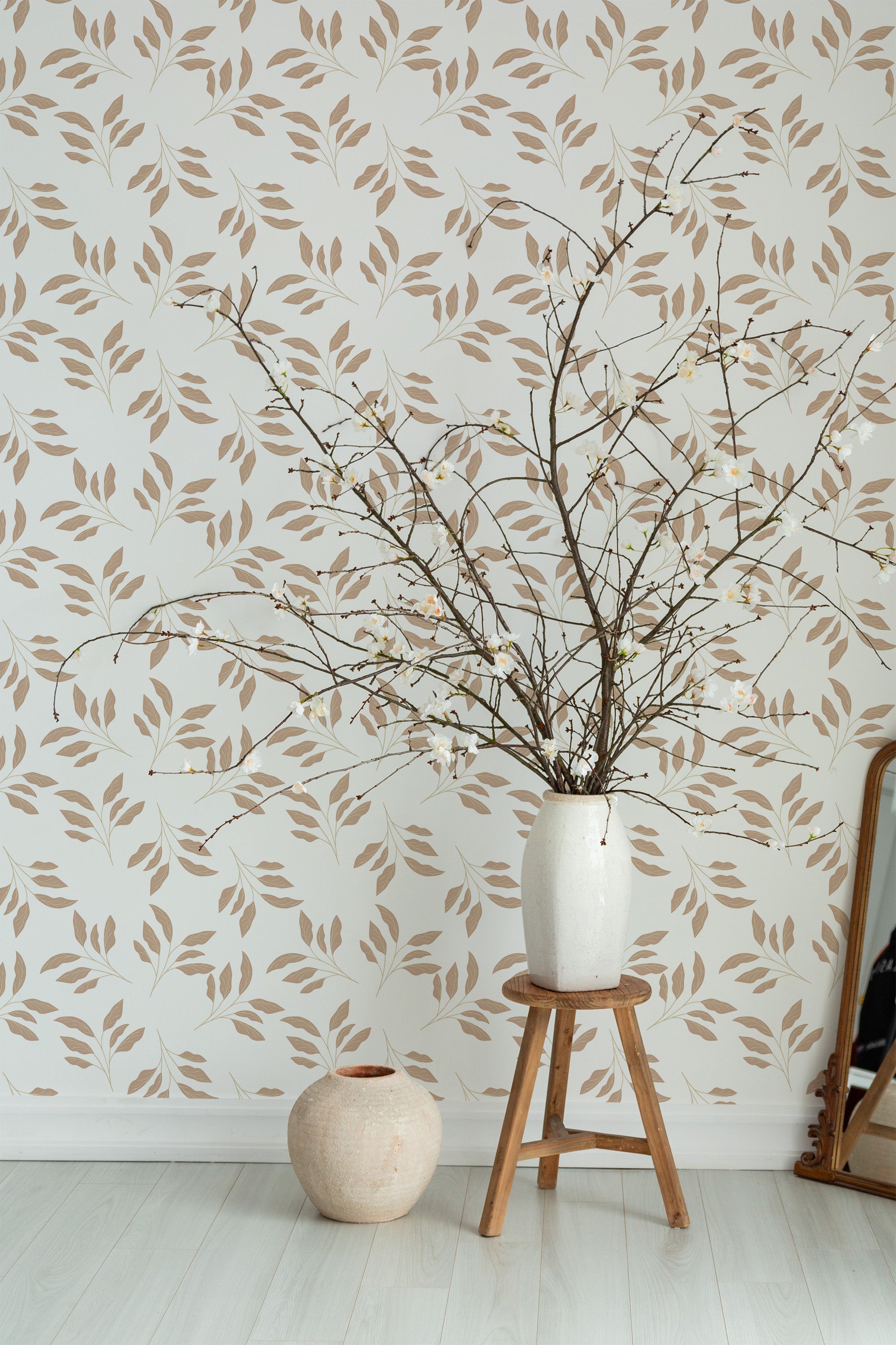 Self-adhesive wallpaper with a Classic leaf design in beige and brown tones on a white background, creating a natural and calming aesthetic in a simple, clean room.