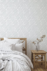 Self-adhesive wallpaper with a diagonal line pattern in a minimalist bedroom.