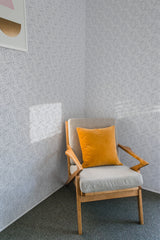 Room with wallpaper adorned with a delicate, intricate leaf pattern in a repeating, seamless design. Traditional wallpaper.