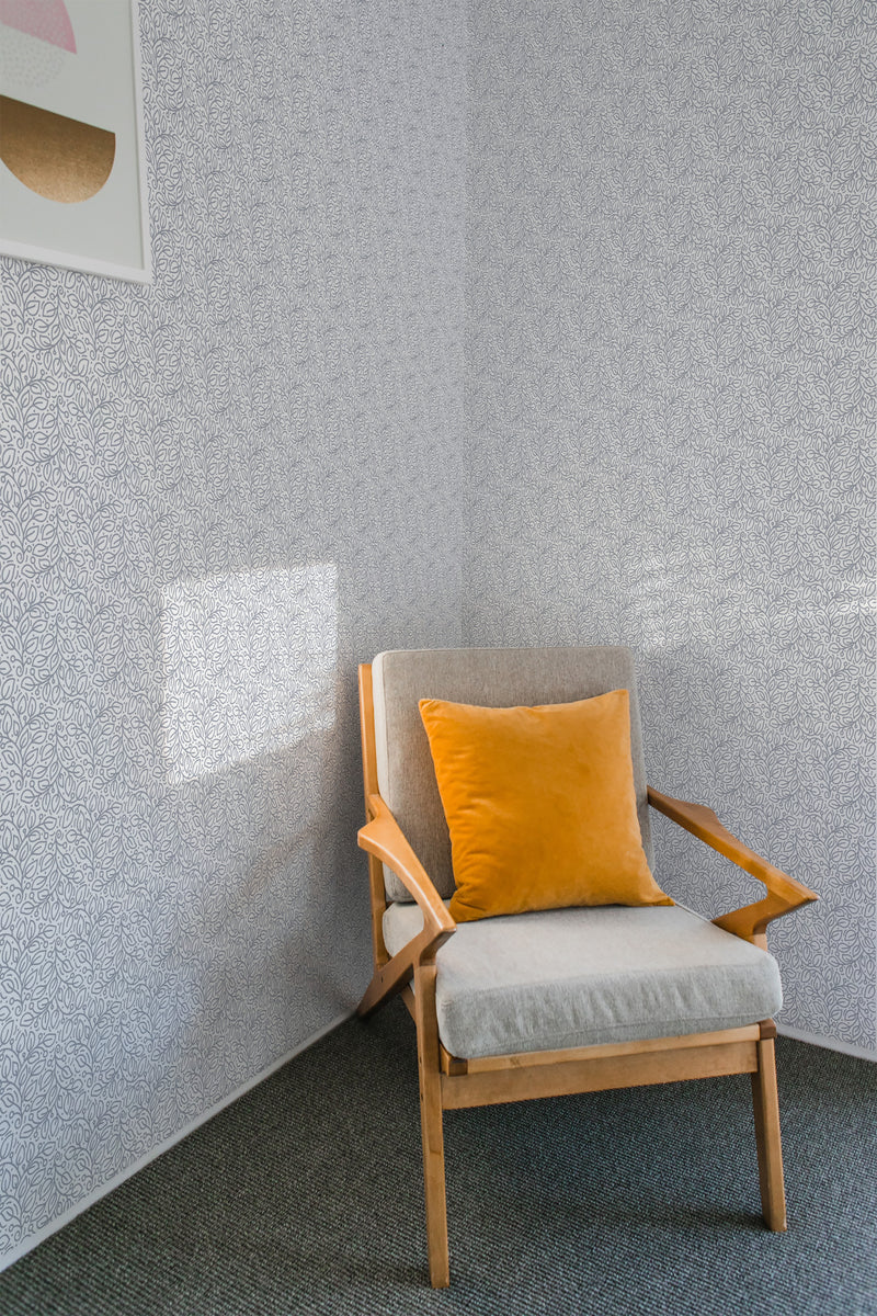 Room with wallpaper adorned with a delicate, intricate leaf pattern in a repeating, seamless design. Traditional wallpaper.