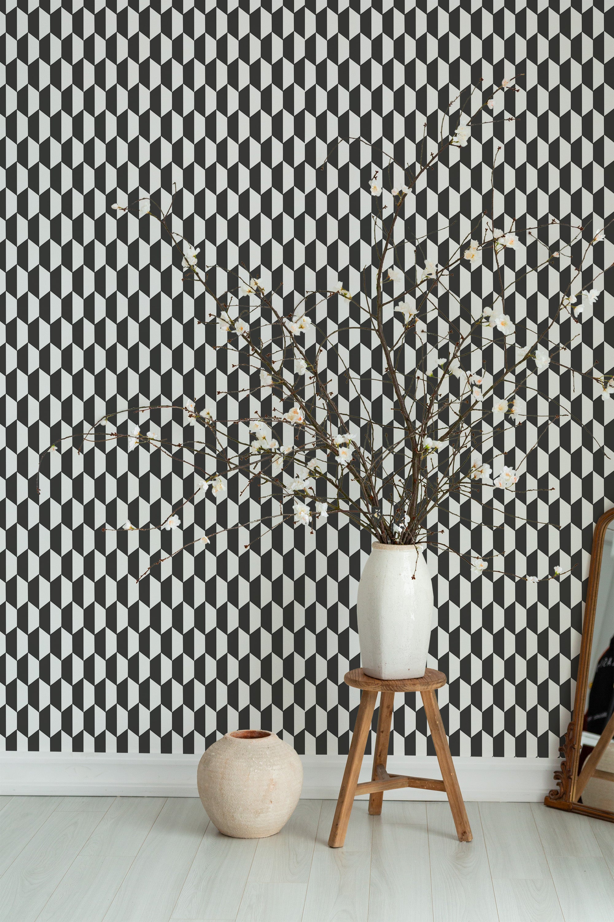 Self-adhesive wallpaper with a bold rhombus pattern in black, white, and gray tones, arranged in a geometric 3D-like optical illusion.