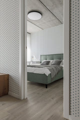 A room with wallpaper featuring a geometric circle line pattern in black on a white background. The wallpaper creates a minimalist and modern aesthetic while maintaining the timeless appeal of traditional wallpaper.