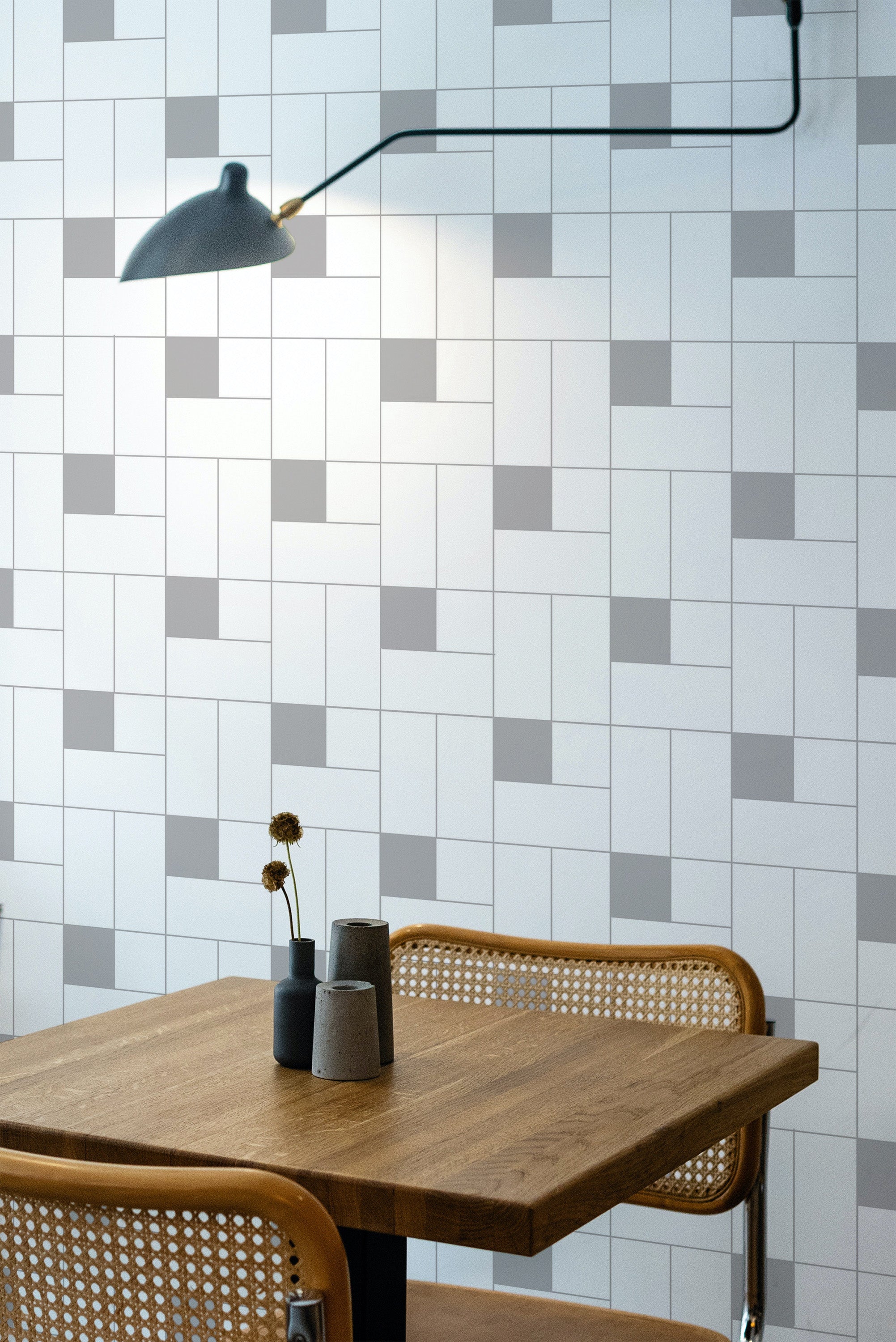 Self-adhesive wallpaper with a Micro tile design, featuring a geometric pattern of small rectangular and square tiles in varying shades of gray and white, arranged in a contemporary, minimalistic style.