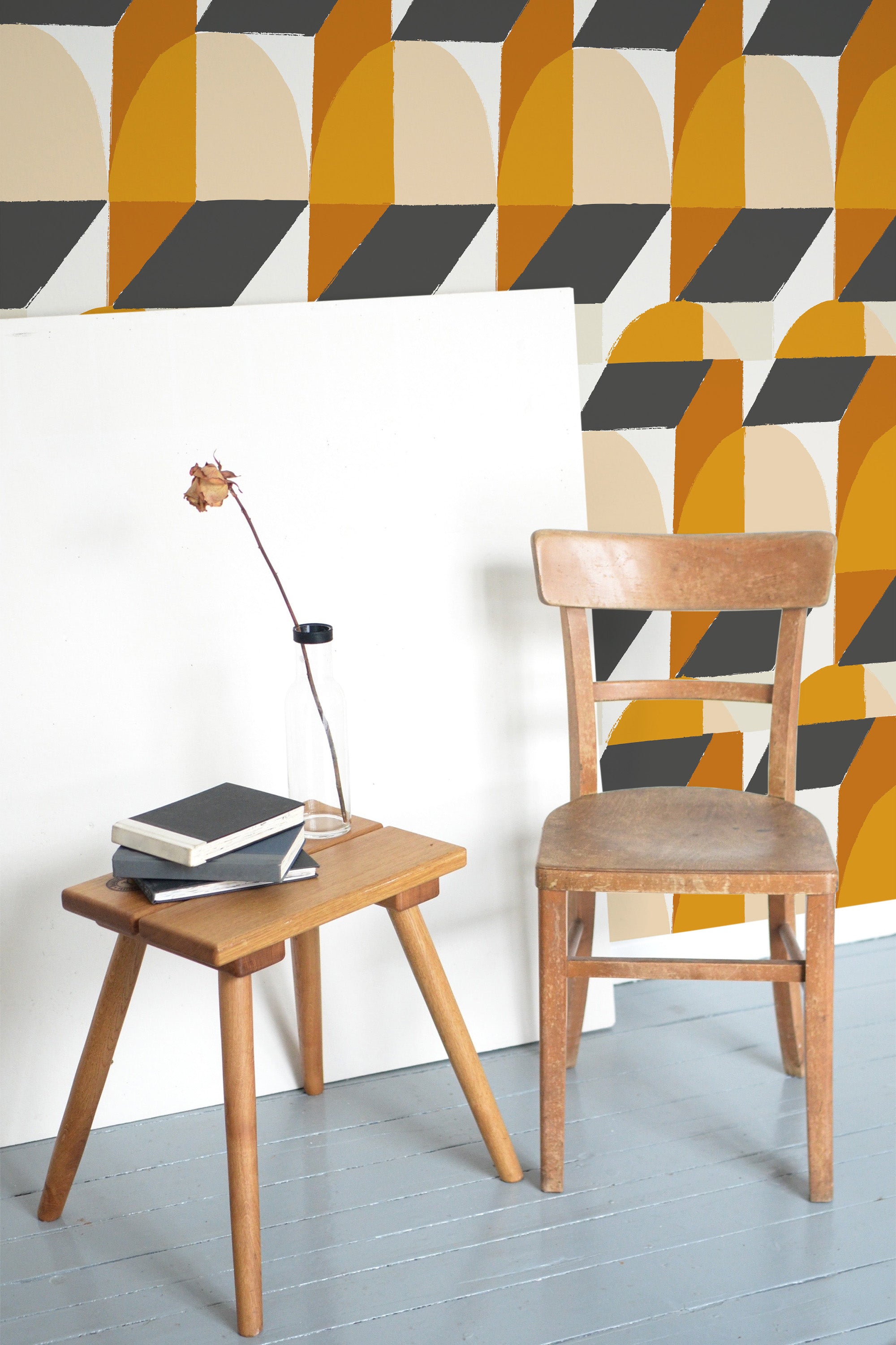 Self-adhesive wallpaper with an abstract geometric design in mustard yellow, beige, black, and grey tones, featuring a pattern of overlapping bold shapes and arches in different orientations.