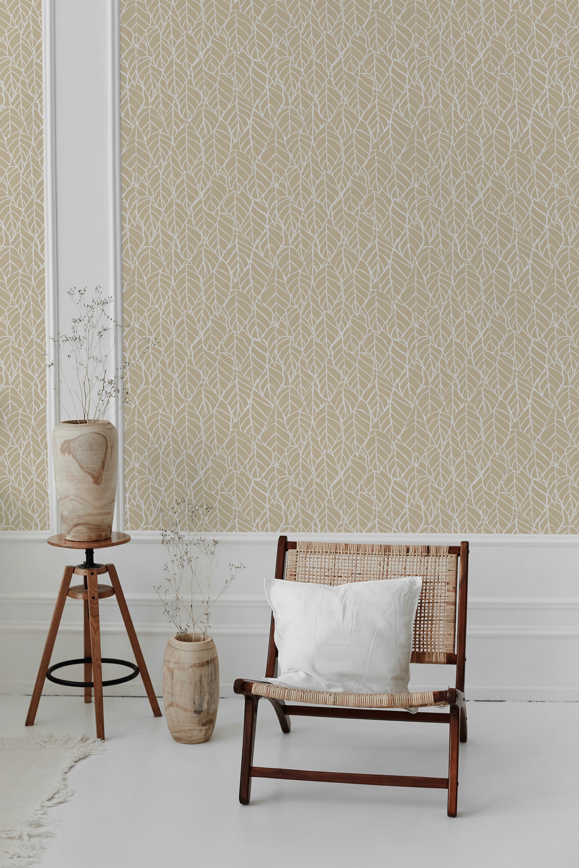 A beige wall adorned with white hand-drawn leaves creating an intricate, nature-inspired pattern. Traditional wallpaper.