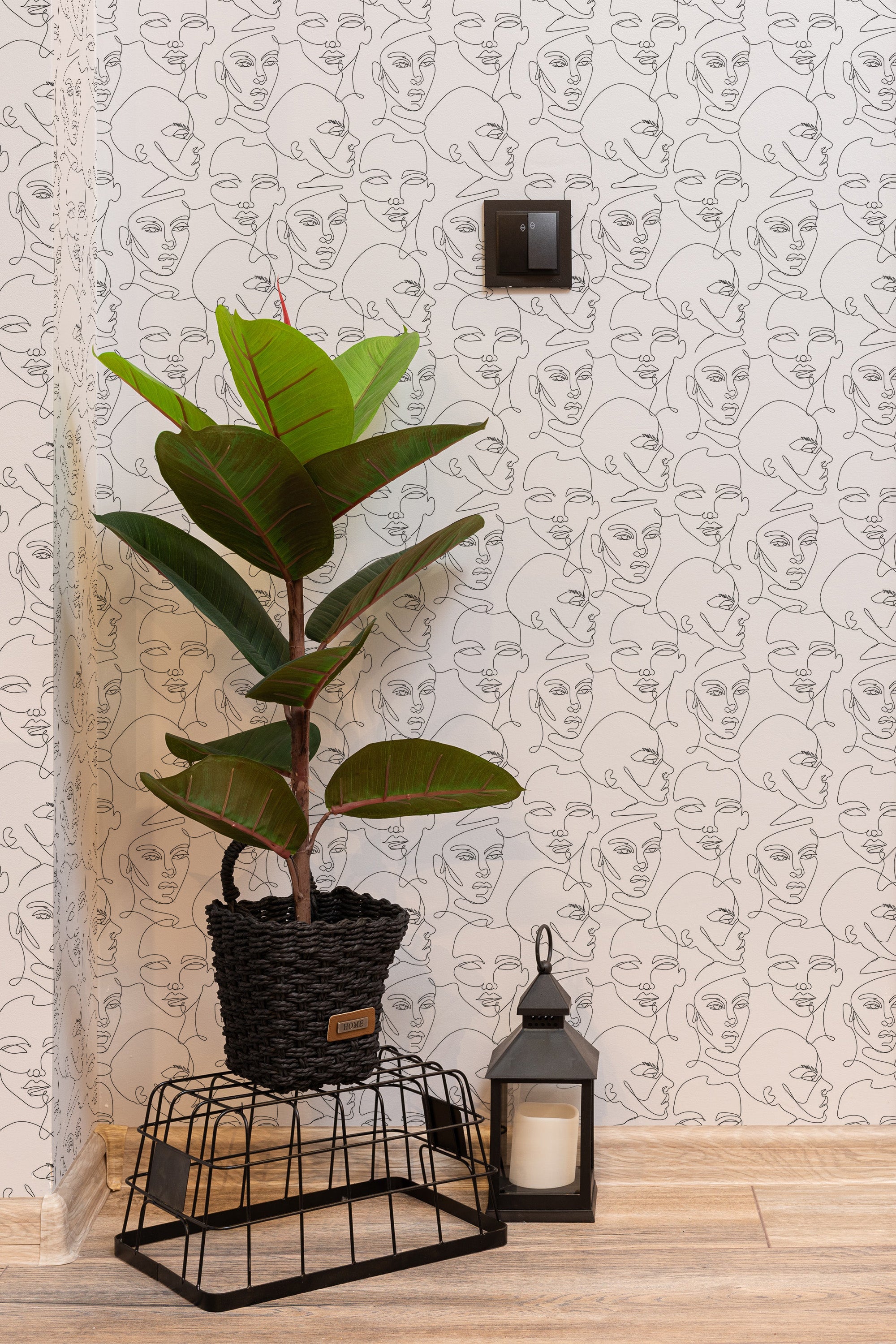 Self-adhesive wallpaper with minimalist line art face design, creating a modern and sophisticated atmosphere.