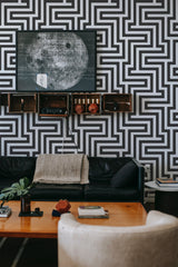 modern sophisticated living room leather sofa black and white geometric peel and stick removable wallpaper
