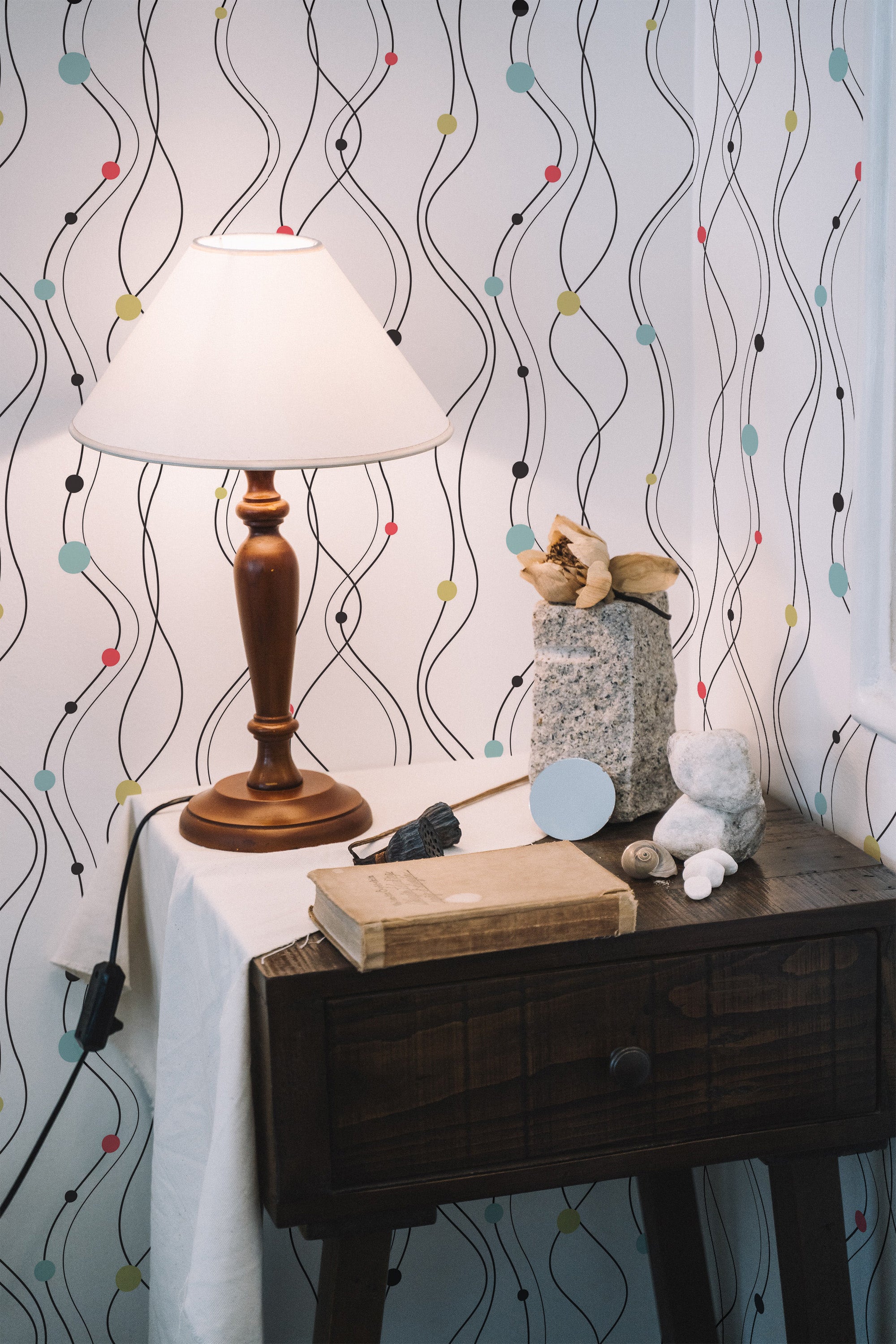 Self-adhesive wallpaper with an abstract lines pattern, featuring flowing black and gray lines intertwined with small color accents in teal, pink, and yellow, creating a modern and stylish look.