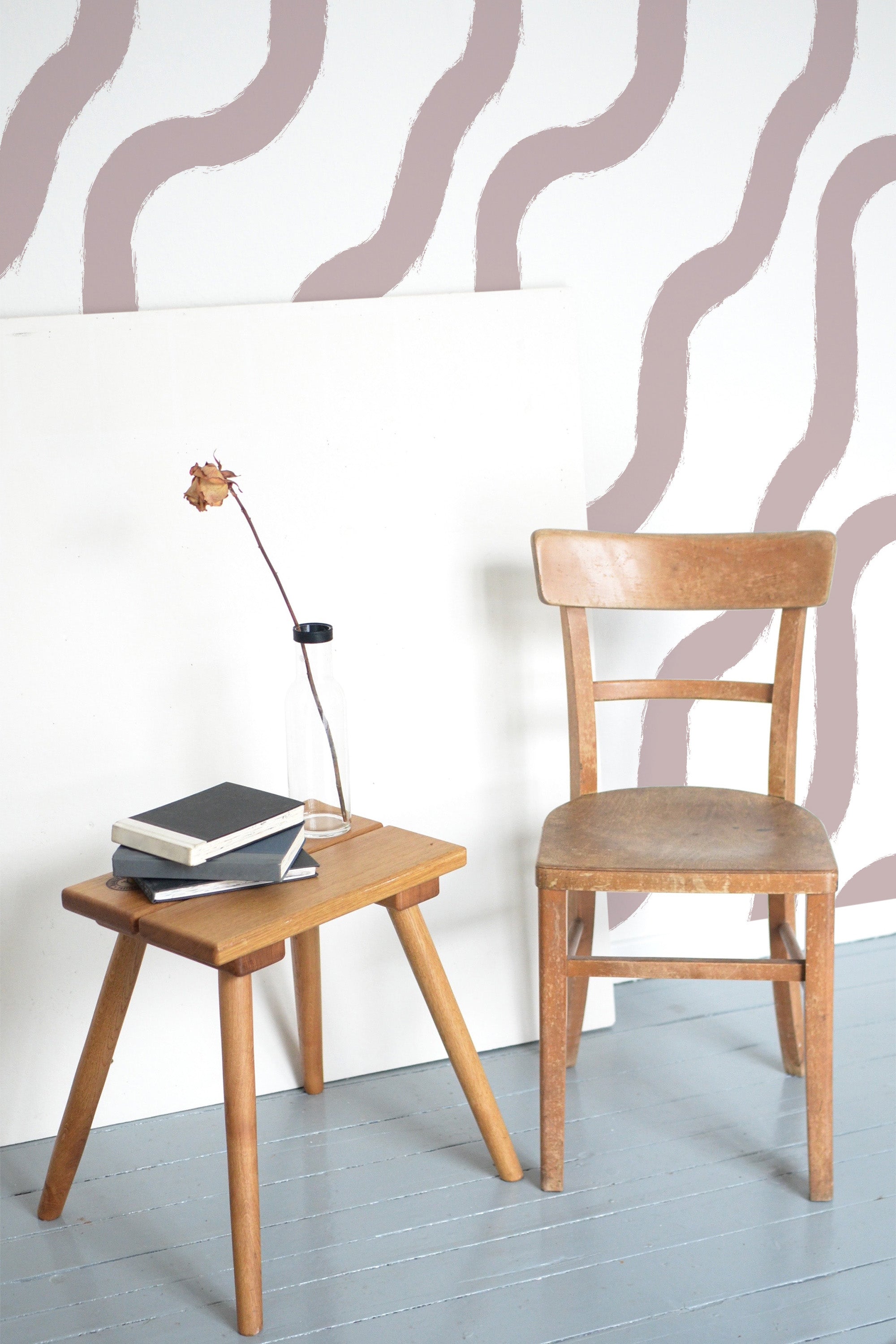 Self-adhesive wallpaper with an abstract brush stroke line design, featuring soft, wavy lines in muted pink tones on a white background.