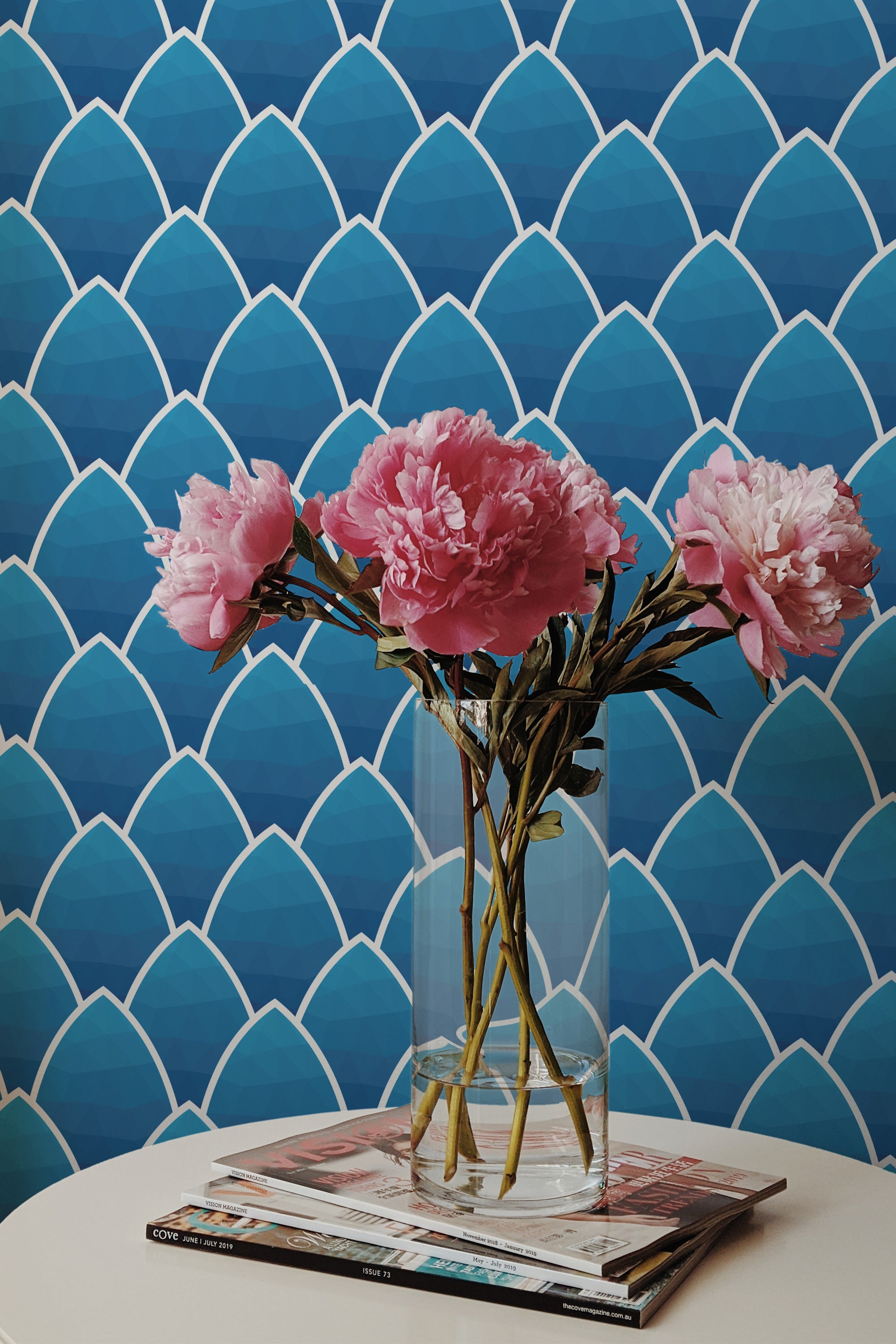 Self-adhesive Blue seamless art deco wallpaper with a vibrant geometric pattern of overlapping scallop shapes in varying shades of blue.