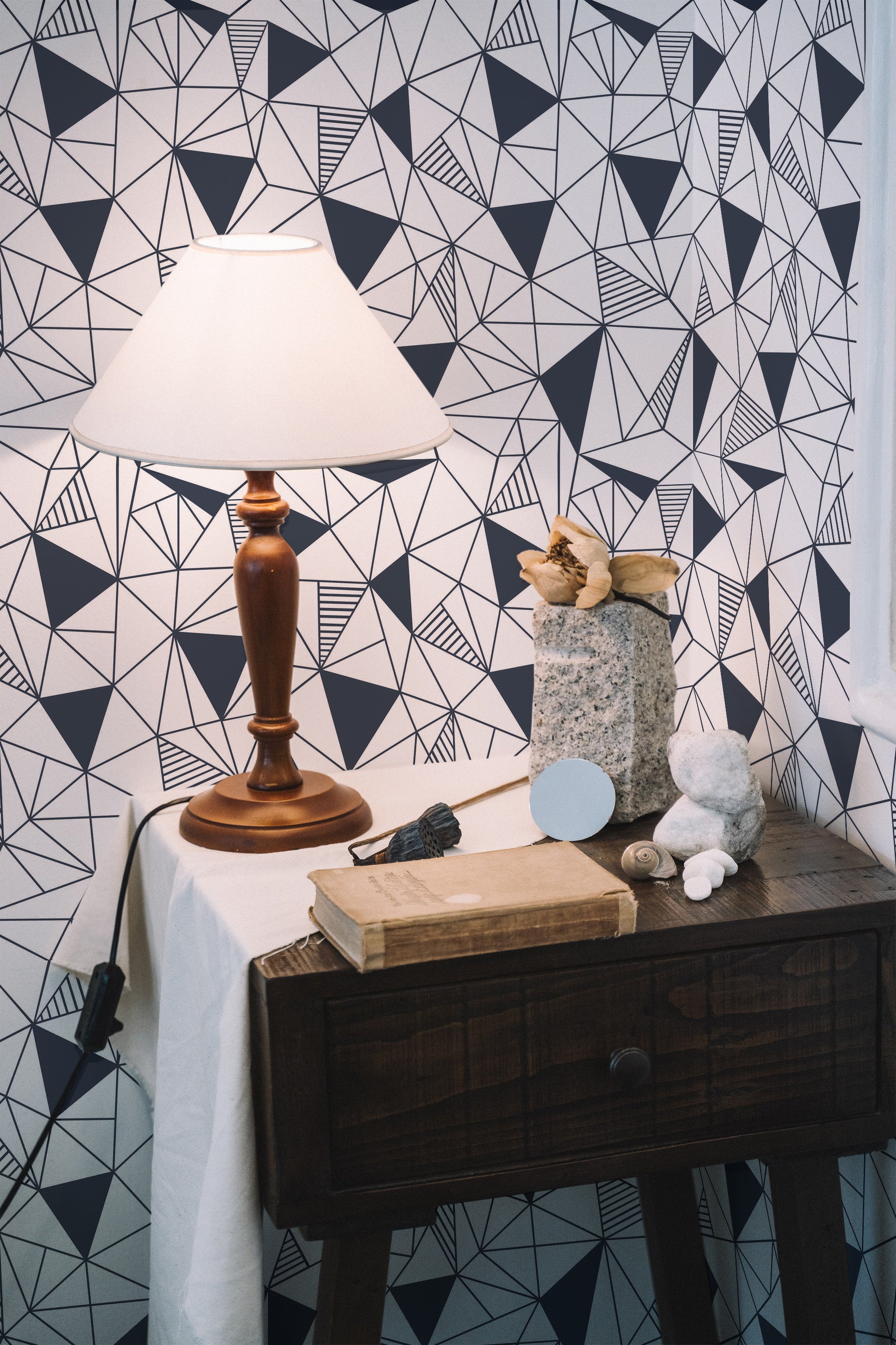 Self-adhesive Navy mosaic wallpaper with an abstract geometric pattern of dark blue and white shapes forming intricate, angular designs, complementing the decor of the room.