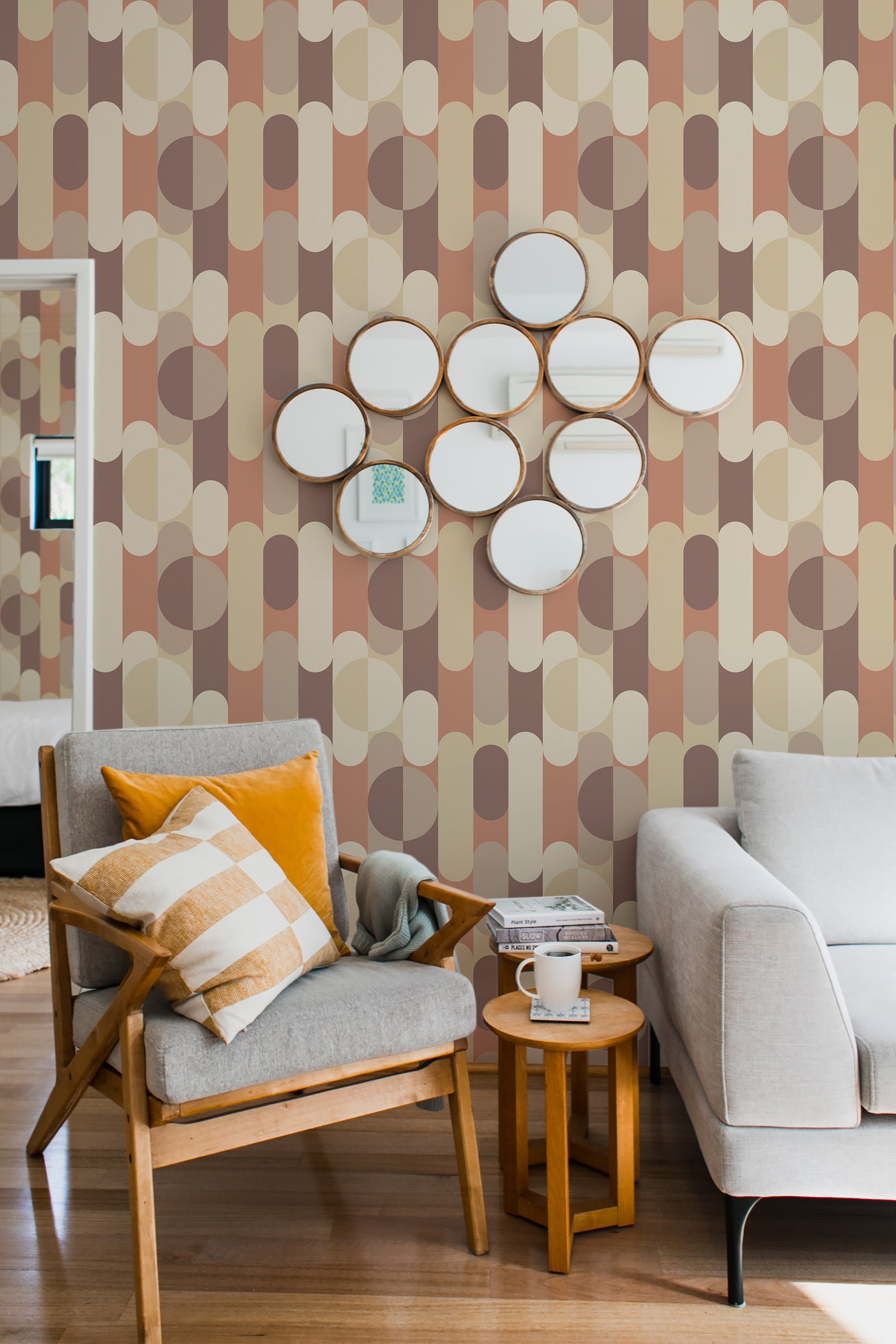 Wallpaper with a Mid-Century Modern design, incorporating geometric shapes in muted tones of beige, brown, and peach circles, and elongated ovals, creating a repeating pattern along the wall, traditional wallpaper.