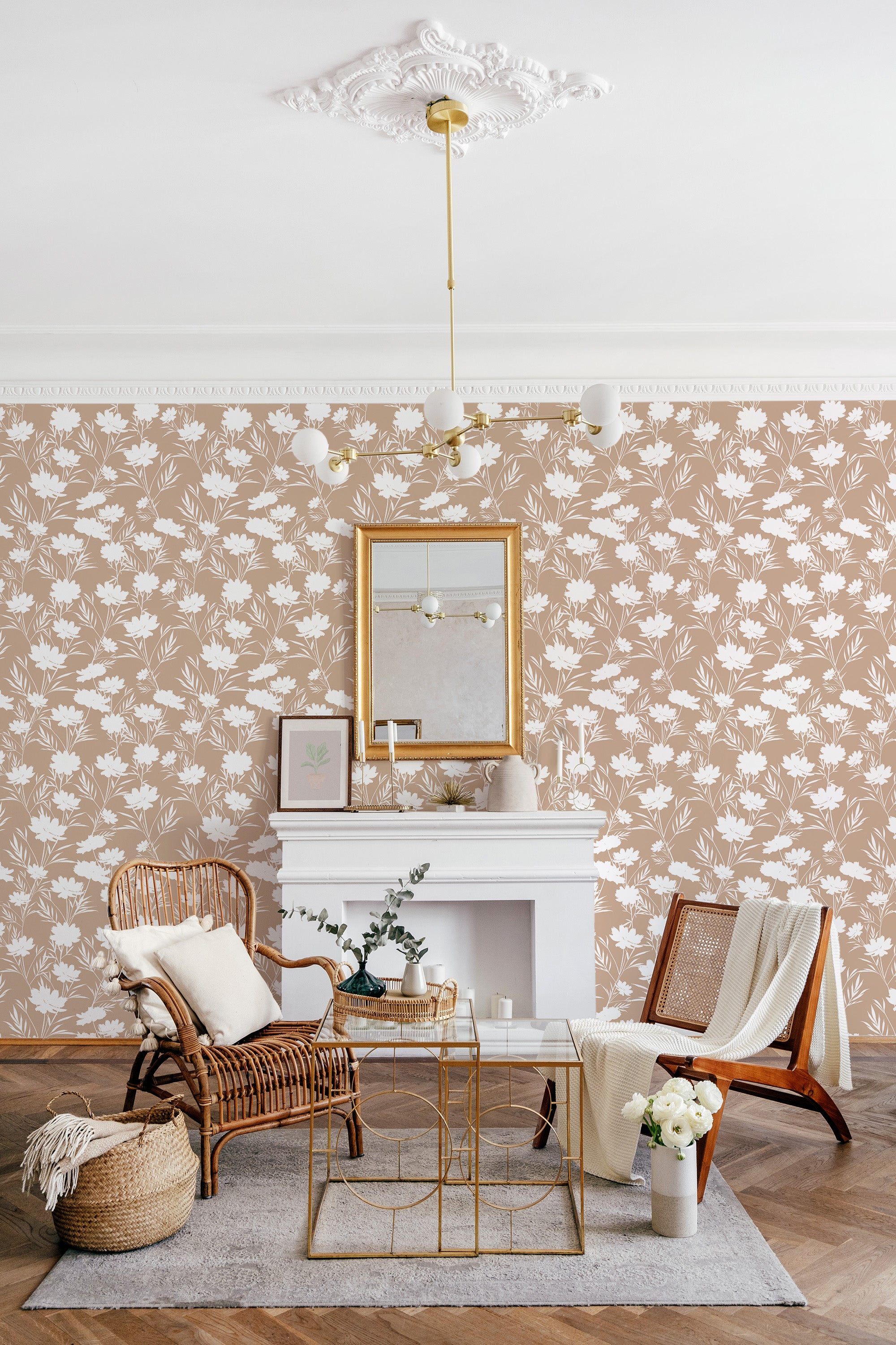 Tan-colored wallpaper with a pattern of white daisies and delicate green leaves in a repeating design. The floral motif creates a vintage, pastoral atmosphere, complementing the room's rustic decor and offering a serene, timeless aesthetic. Traditional wallpaper.