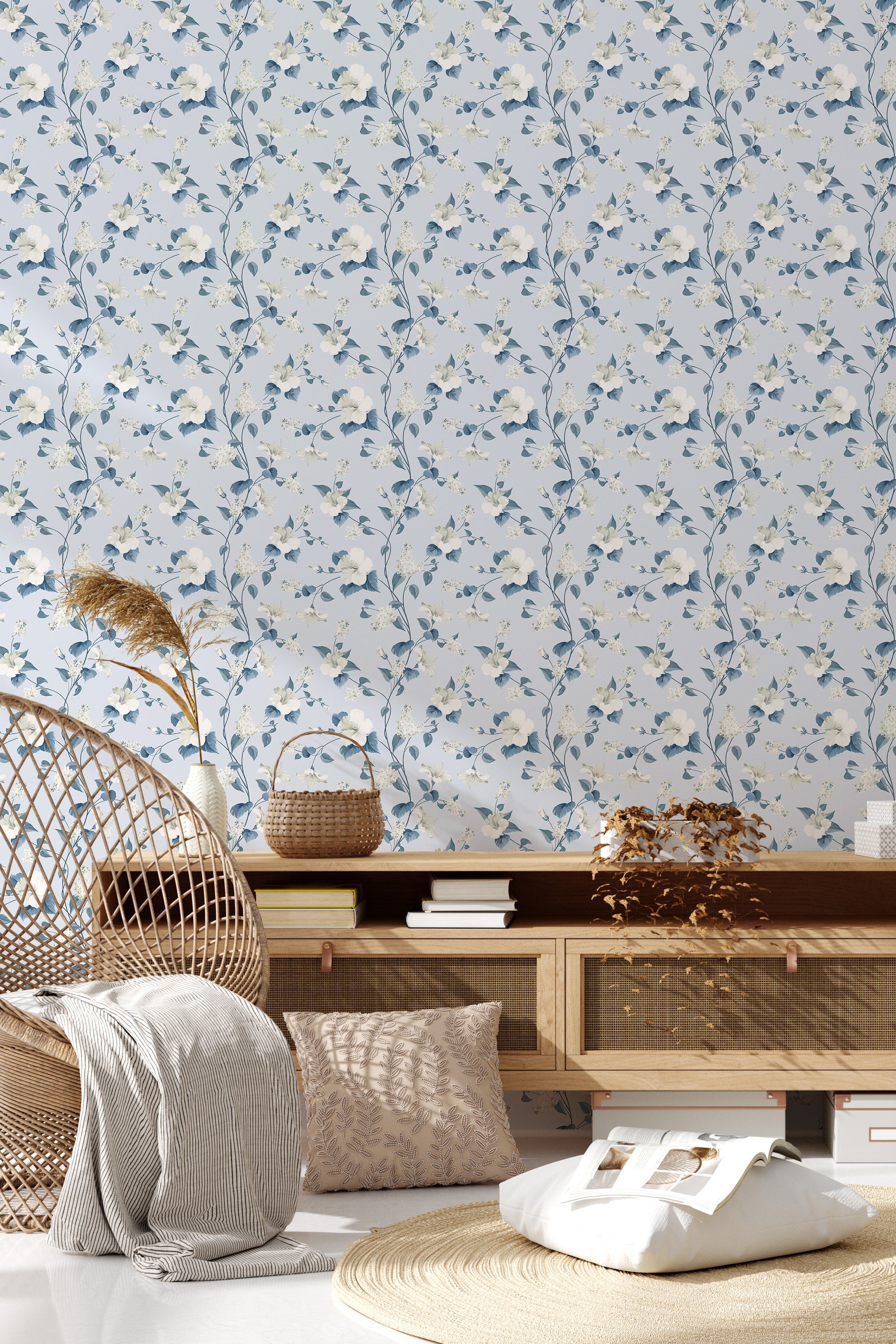 White-based wallpaper with delicate blue floral patterns and subtle green leaves in a repeating vertical motif, creating a serene and elegant look. Traditional wallpaper.