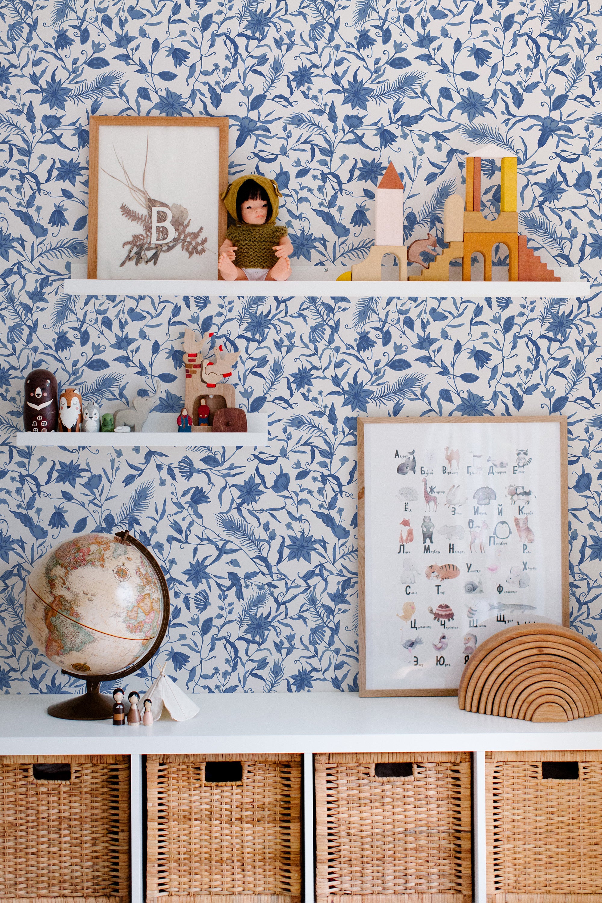 Self-adhesive wallpaper in a blue farmhouse design with detailed botanical patterns, including leaves and flowers, creating a vintage-inspired, country-chic aesthetic in the room.