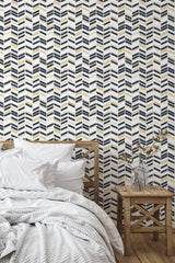 Self-adhesive Art Deco chevron wallpaper, with alternating gold, navy, and white patterns creating a bold, geometric zigzag design on a neutral background.