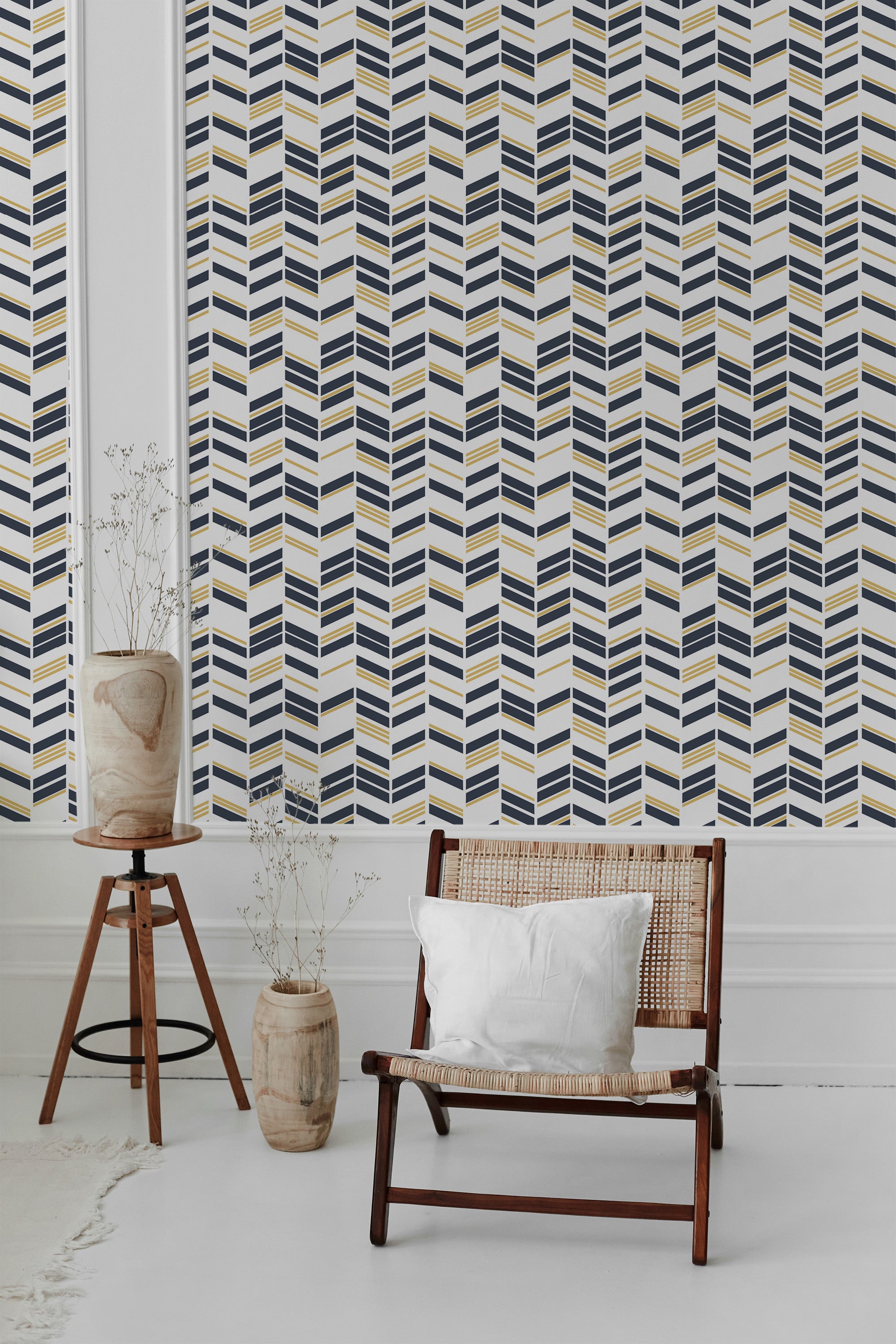 A room with Art Deco chevron wallpaper in navy blue, gold, and white, arranged in geometric zigzag patterns. Traditional wallpaper.