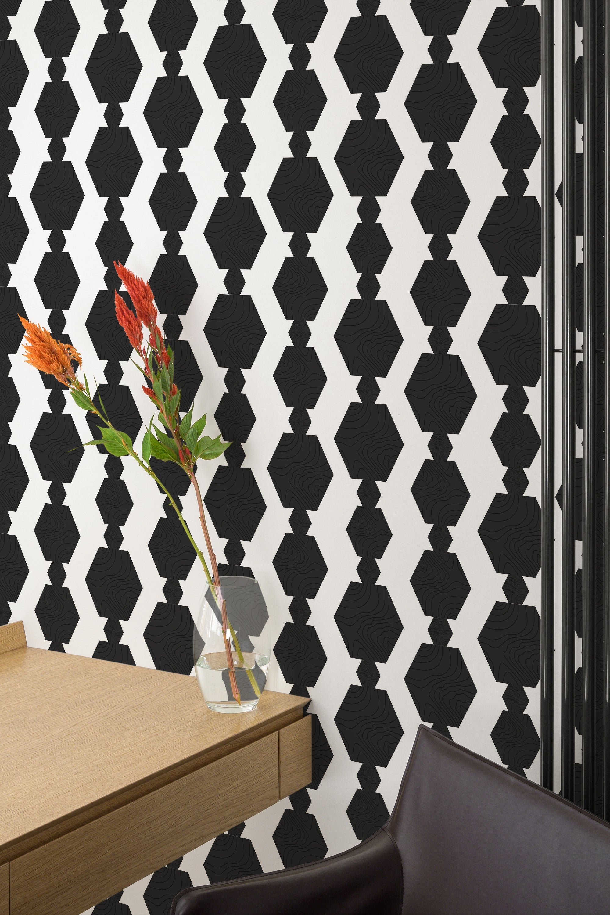 Self-adhesive black bold geometric wallpaper with a striking pattern of interconnected diamond shapes against a white background.