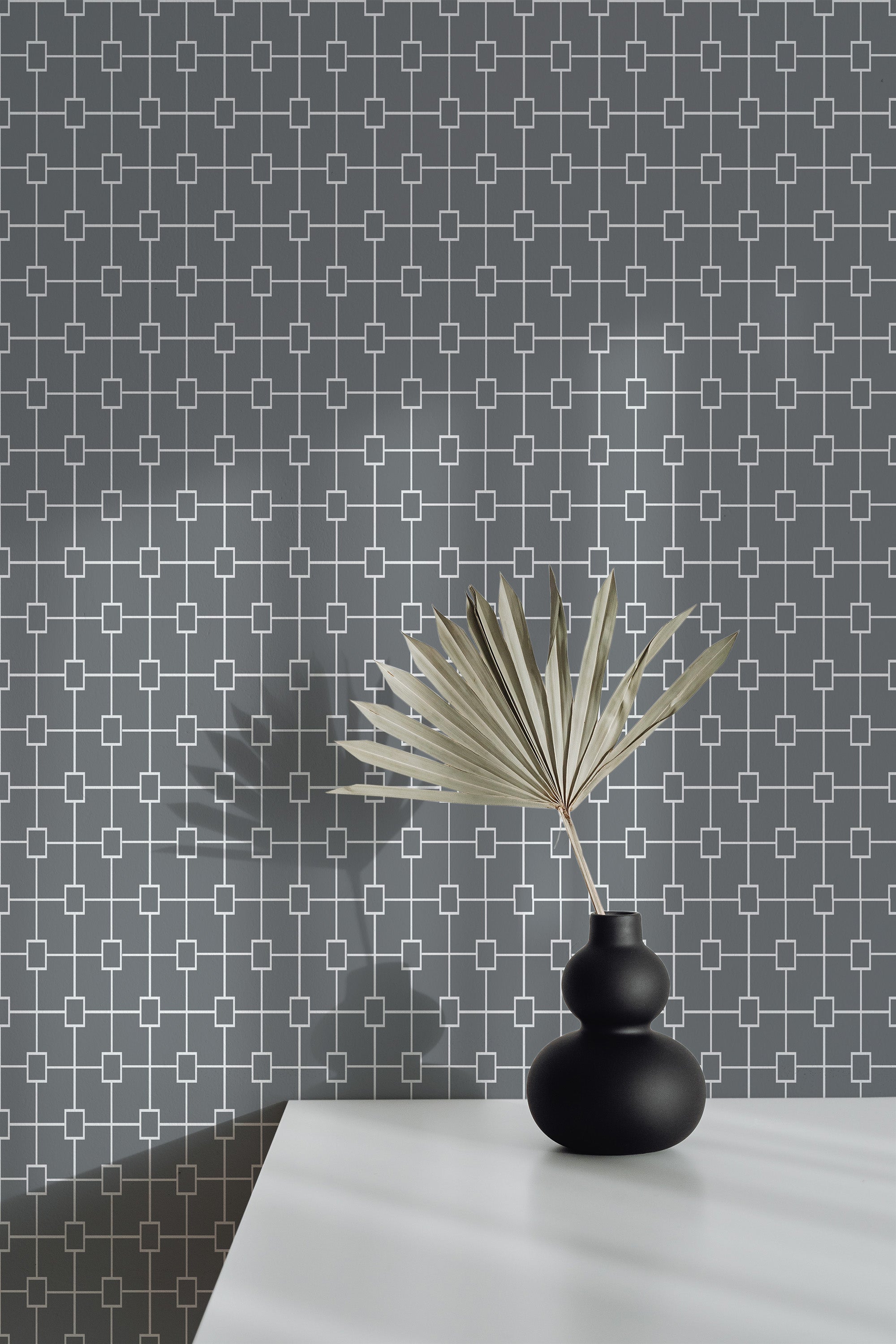 Self-adhesive geometric grid wallpaper in shades of grey with white intersecting lines creating a modern, stylish pattern.