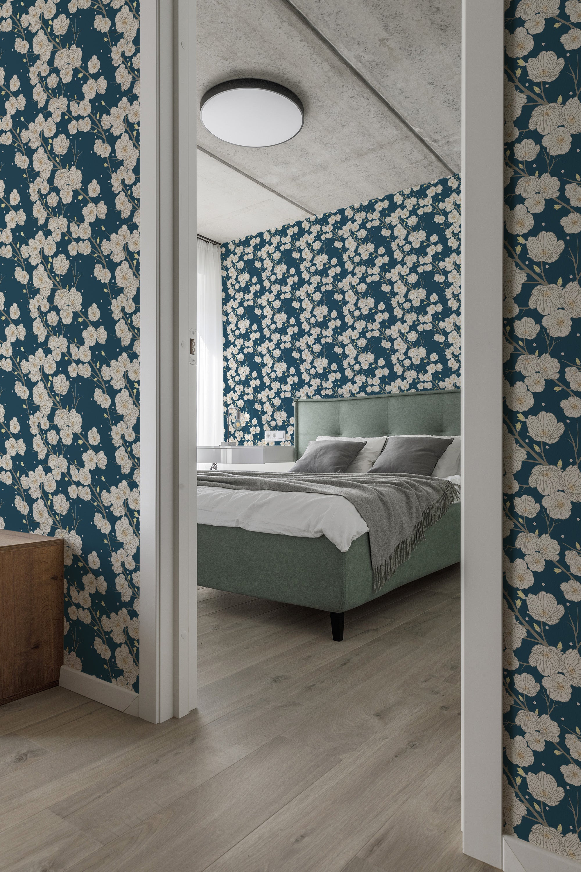 Dark blue floral wallpaper with a repeating pattern of white flowers and green leaves. The design adds a classic and elegant touch to the room, enhancing the traditional wallpaper.