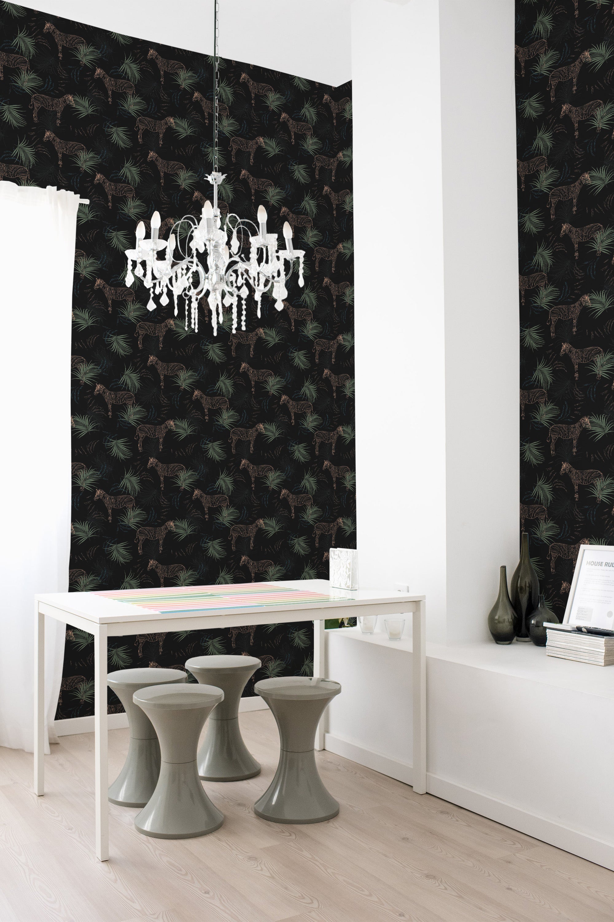 Dark jungle animal wallpaper with intricate patterns of leopards and lush green leaves against a black background in a modern room with a chandelier and minimalist furniture. Traditional wallpaper.