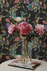 Self-adhesive wallpaper with an exotic bird design, against a dark background. Vibrant peacocks and colorful flowers in vivid hues create a lively and luxurious atmosphere.