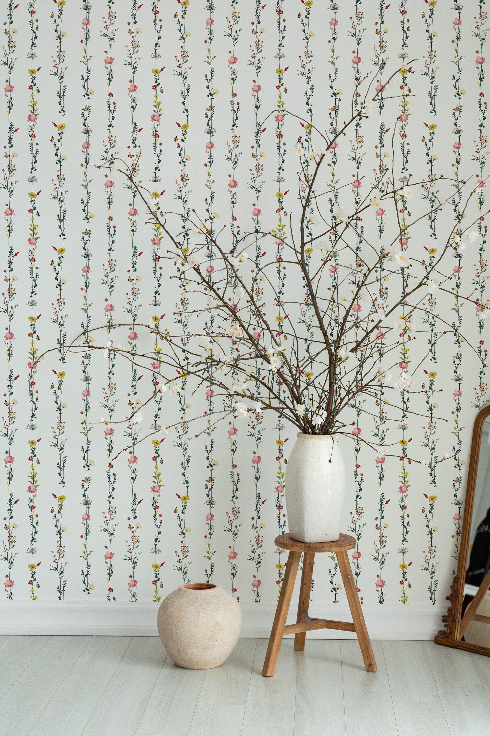 Self-adhesive wallpaper with a minimal floral line design, featuring delicate, vertical lines of small, colorful flowers on a white background.
