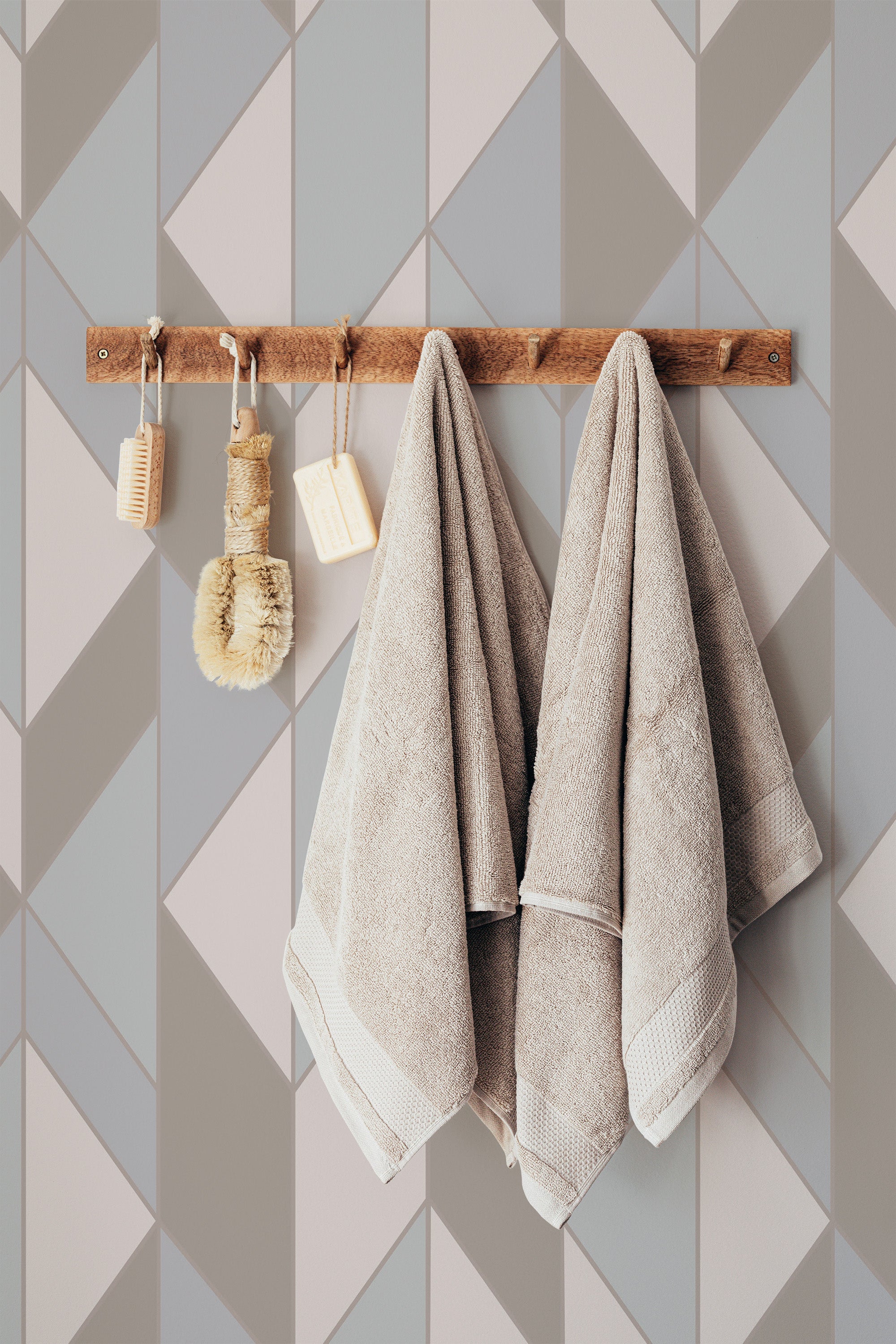 Self-adhesive retro mosaic wallpaper with geometric patterns of interlocking triangles and parallelograms in varying shades of grey and beige, creating a modern, minimalist style.